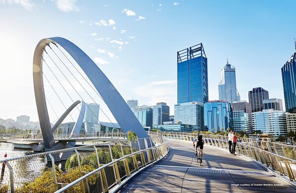 A modern bridge with a unique arch design, leading to a cityscape with high-rise buildings. - Citadines St Georges Terrace Perth (Perth)