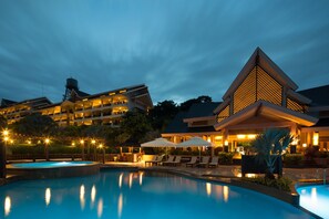 A hotel with a swimming pool, outdoor lounge area, and multiple buildings with balconies. - Alta Vista De Boracay (Boracay Island)
