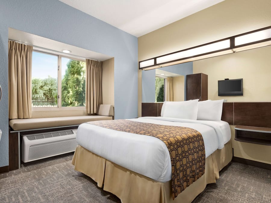 Premium bedding, pillow-top beds, desk, laptop workspace