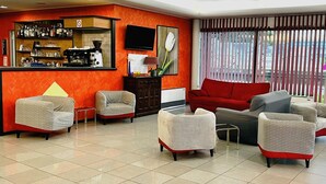 A hotel lobby with a bar area, seating arrangements, and a large window with blinds. - Art & Hotel Treviolo (Treviolo)