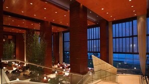 A spacious lobby with a staircase, large windows, and indoor plants. - Kempinski Hotel Suzhou (Suzhou)