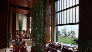 A spacious lobby with a high ceiling, large windows offering a view of the outdoors, and a variety of seating arrangements. - Kempinski Hotel Suzhou (Suzhou)