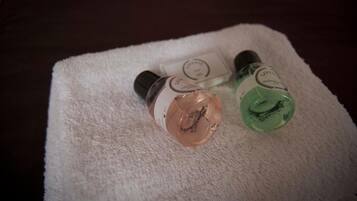Two bottles of liquid on a white towel.