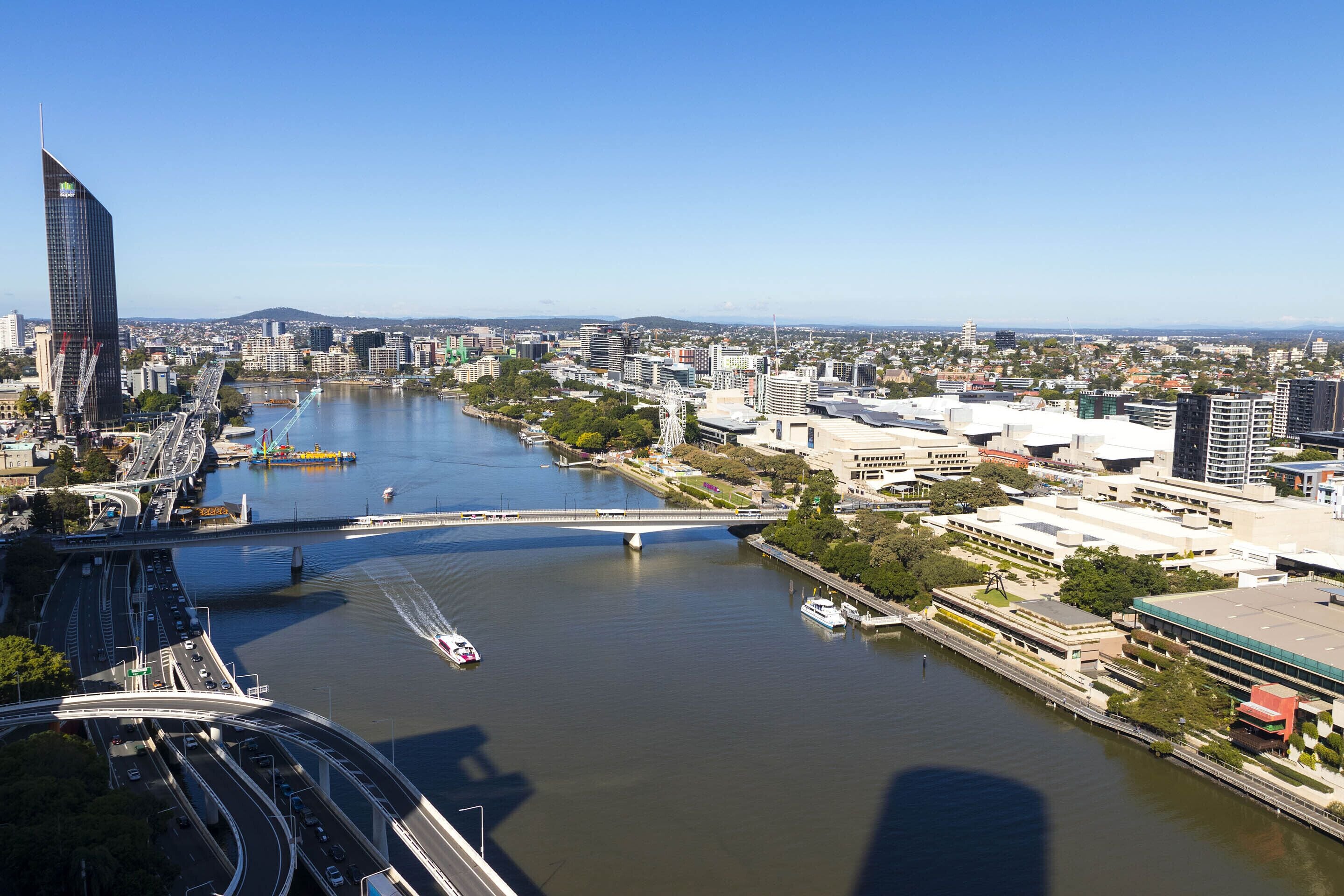A cityscape with a river, bridges, and modern buildings.