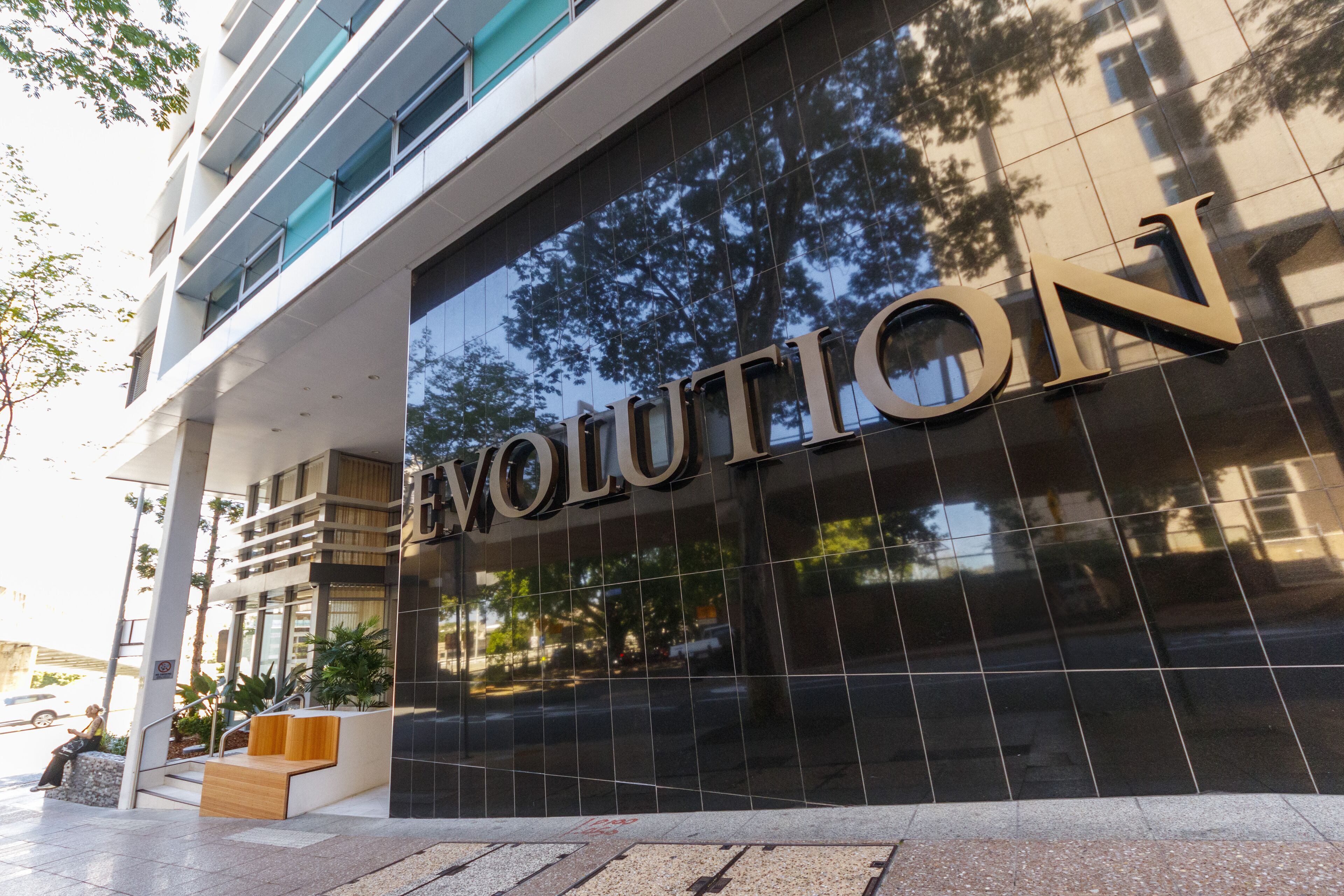 A modern building facade with the word "EVOLUTION" prominently displayed.