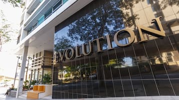 A modern building facade with the word "EVOLUTION" prominently displayed.