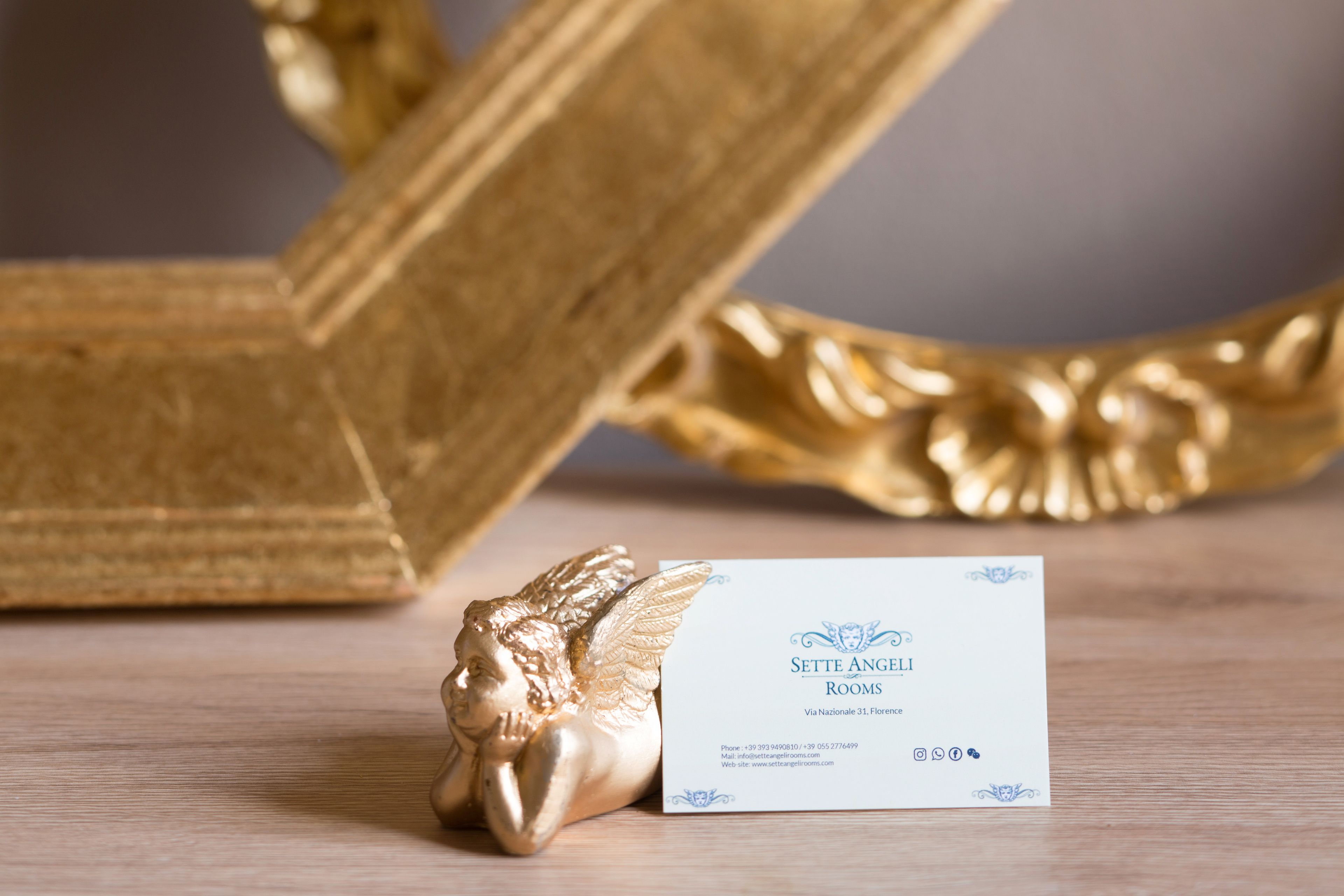 A business card for 'Sette Angeli Rooms' with contact information and a website URL.