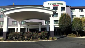A Courtyard Marriott hotel with a covered entrance, multiple floors, and a landscaped front garden.