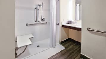 Een badkamer met een douche, toilet en wastafel.