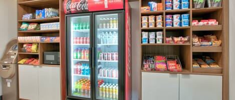Una máquina expendedora y un refrigerador de Coca-Cola en una tienda.