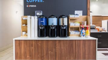 A coffee station with three coffee dispensers, a stack of white cups, and a sign that says "HAVE COFFEE. EXPRESS".