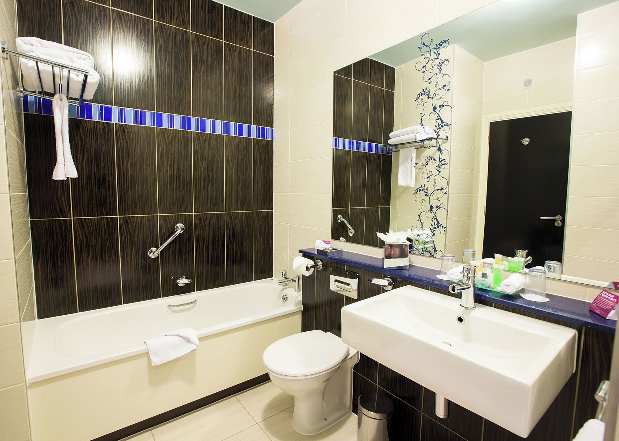 A modern bathroom with a bathtub, a sink, and a toilet.
