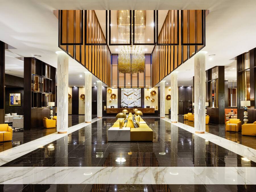 A spacious lobby with a central seating area, high ceilings, and modern decor.
