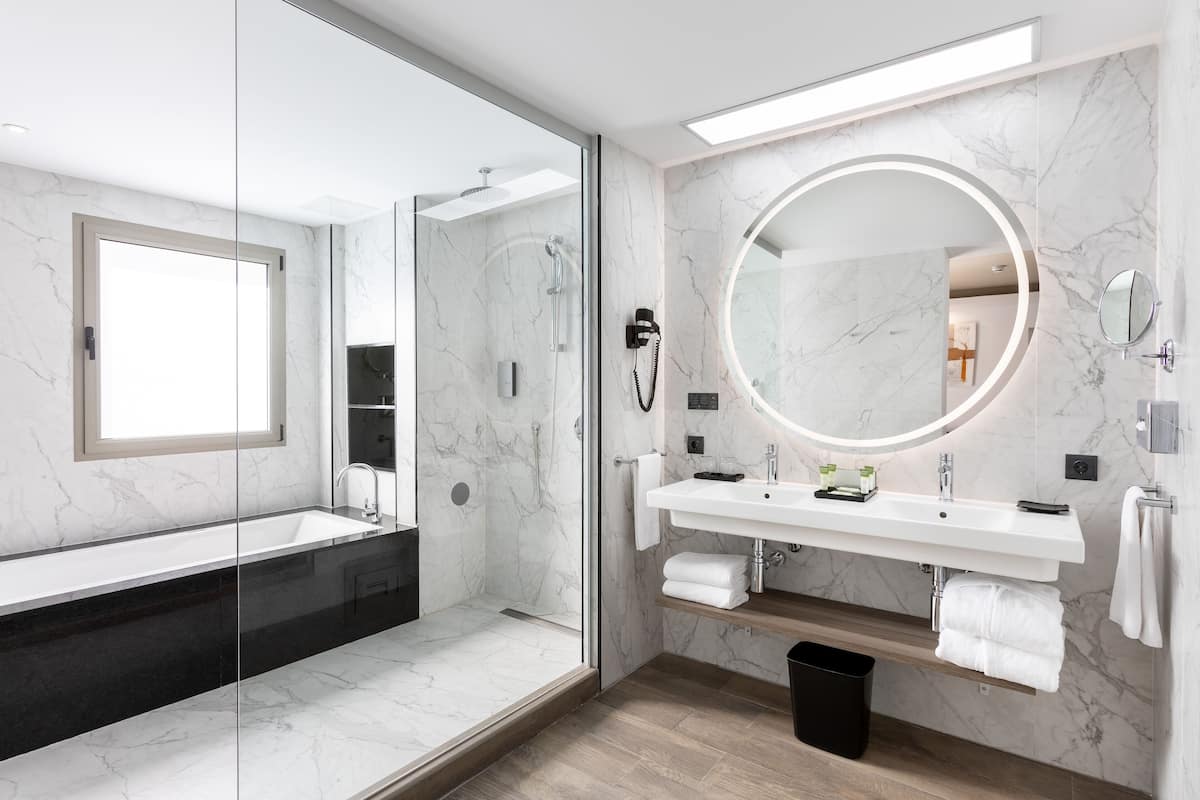 junior suite | bathroom | shower, eco-friendly toiletries, hair dryer, bathrobes