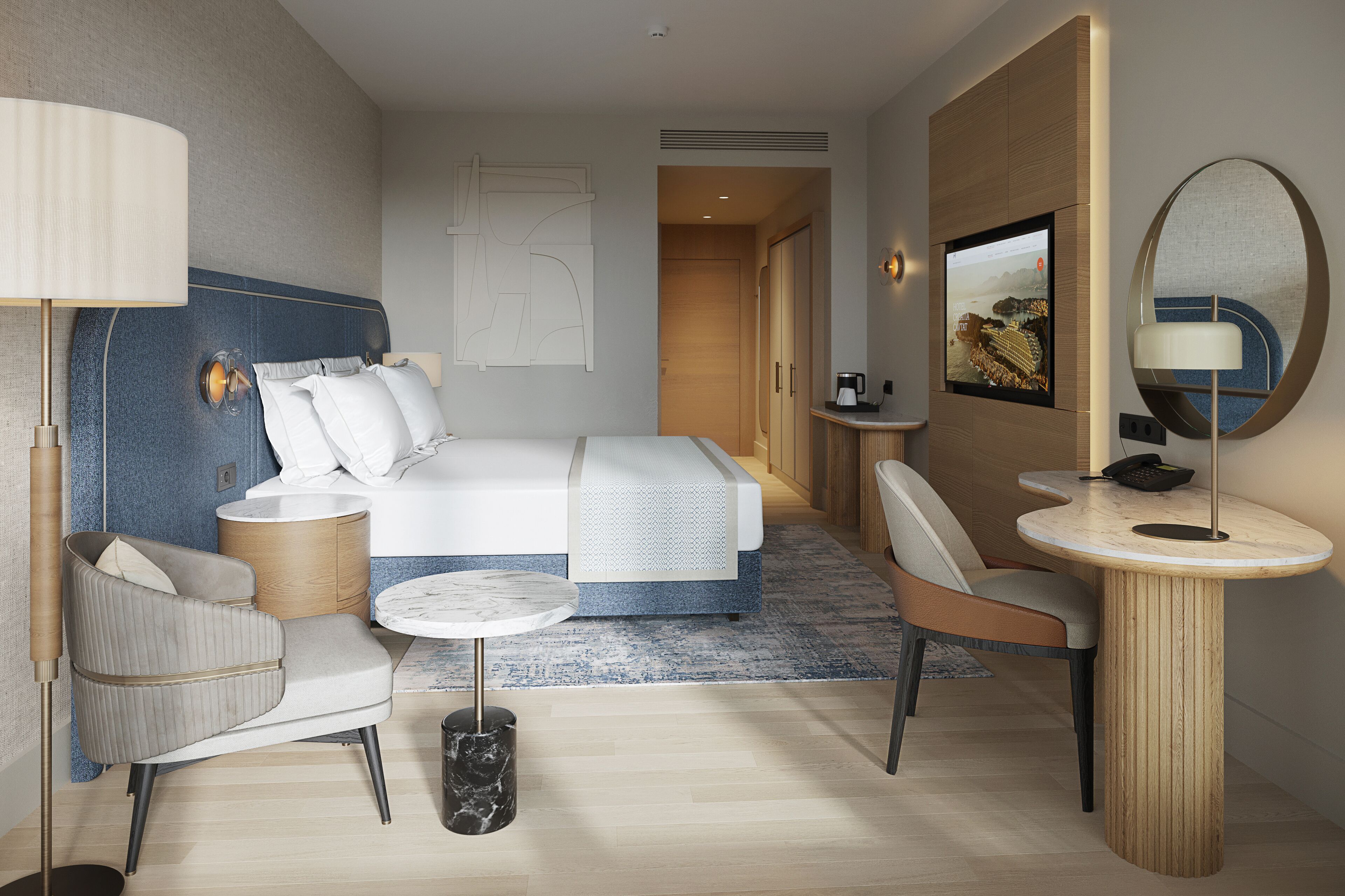 Une chambre d’hôtel moderne équipée d’un lit, d’un coin salon et d’un bureau.