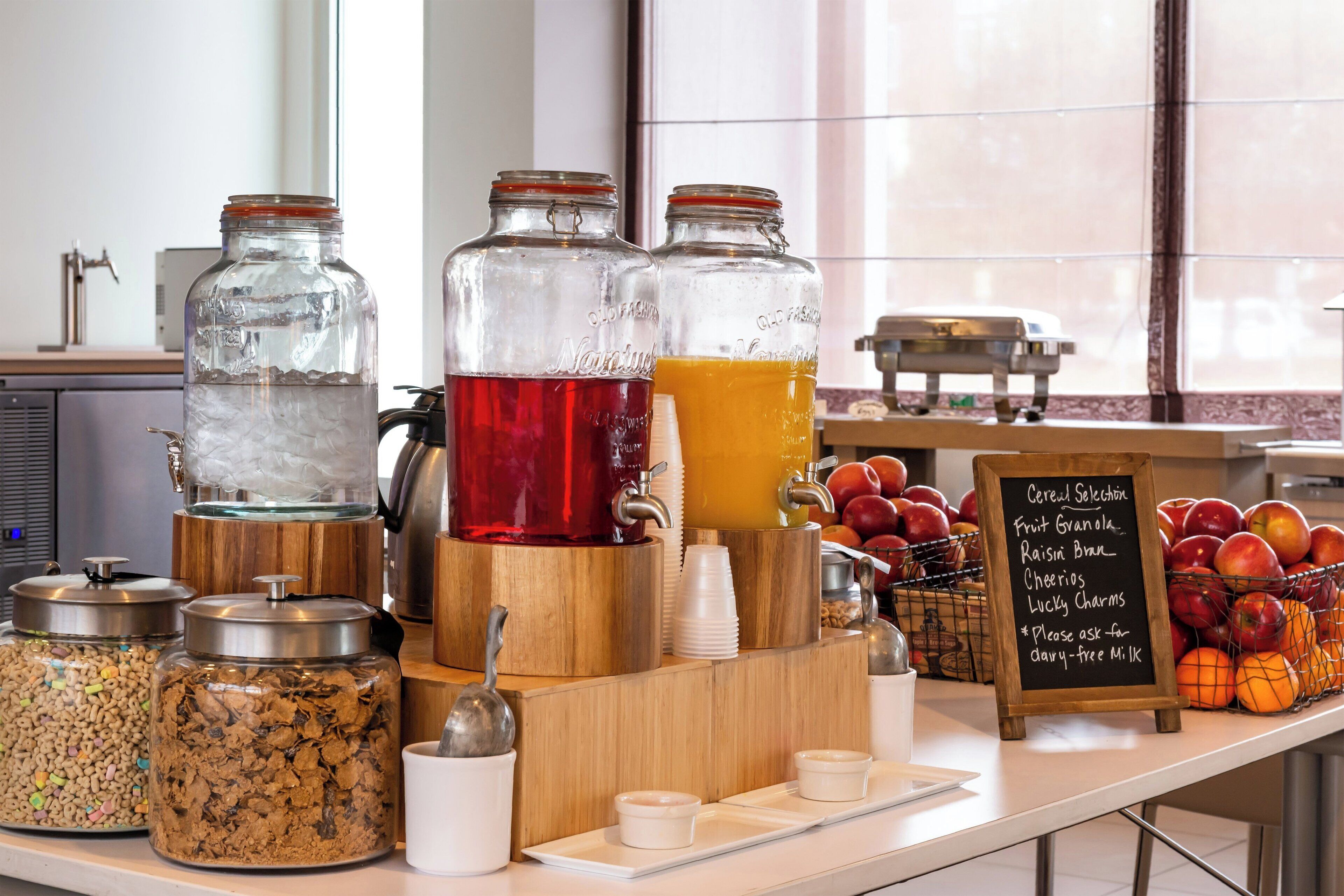 A breakfast buffet with various food options and beverages.