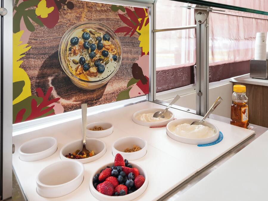 A breakfast buffet with various food items and a decorative wall.