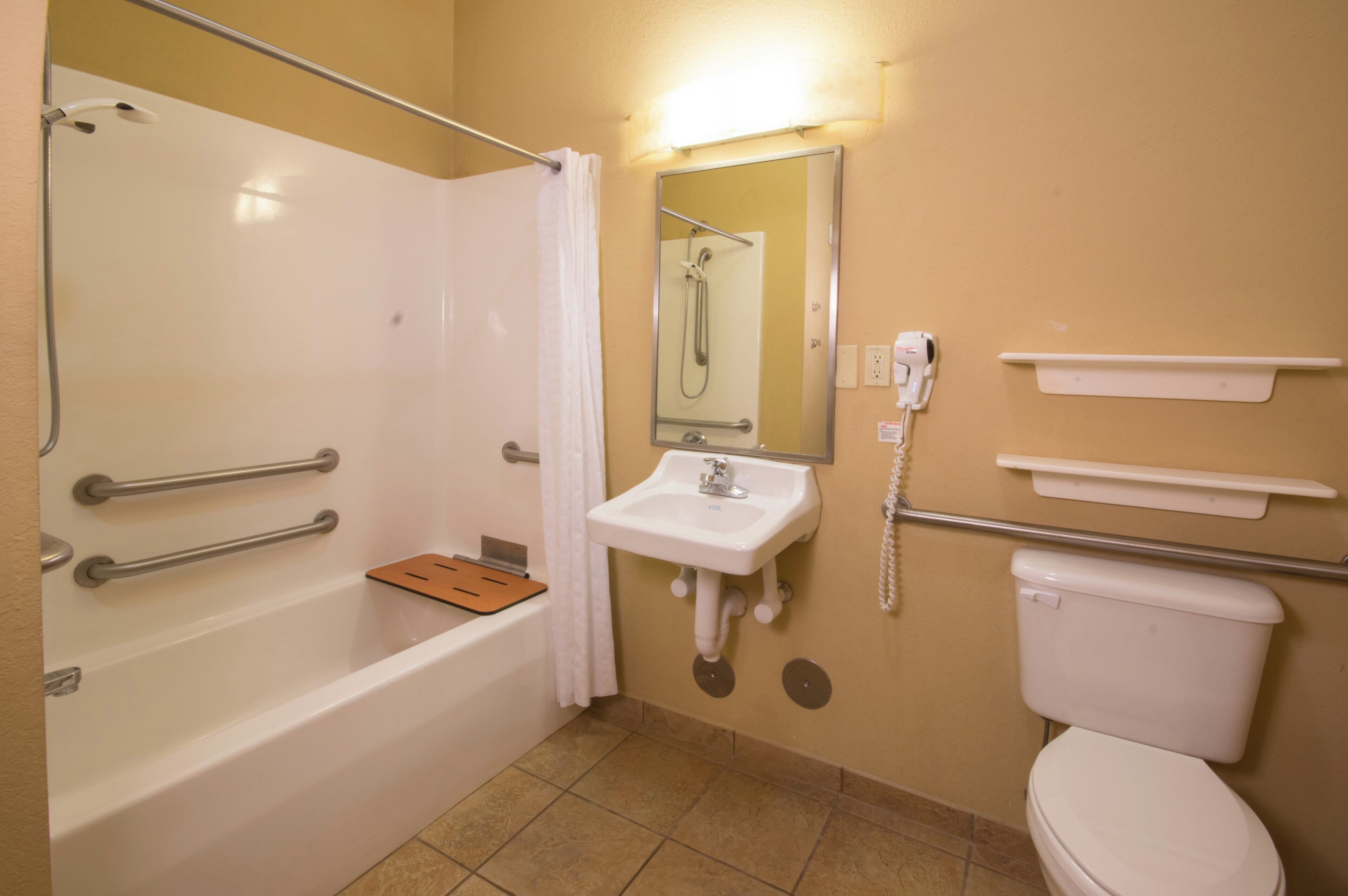 A bathroom with a bathtub, a sink, a toilet, and a shower.
