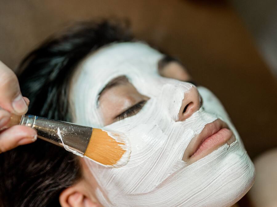 Una persona recibiendo un tratamiento facial con un cepillo.