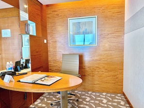 Relax in this inviting room with a large window, round table, and comfortable chair.
