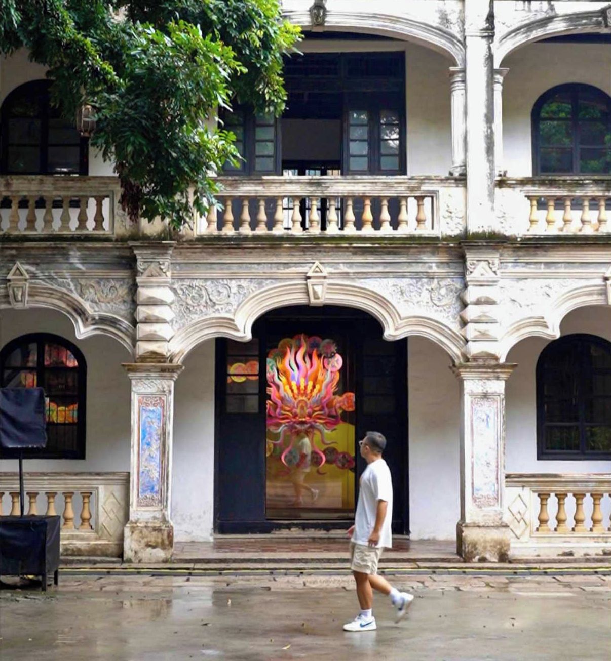 A historic building with ornate architectural details, including a prominent entrance with a colorful mural.