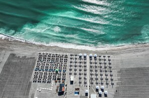 An aerial view of a beach with rows of tents and a sandy beach. - Iaki Hotel (Constanta)