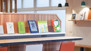 Un espace de travail moderne avec un bureau en bois, cinq livres et deux chaises.