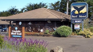A Gualala Bluff Trail sign and a Surf Motel sign with a whale silhouette. - Surf Inn (Gualala)