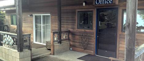A wooden building with a sign reading "Office" above the door.