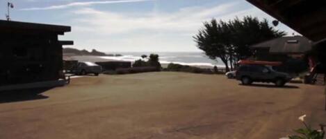 A parking area with a view of the ocean.