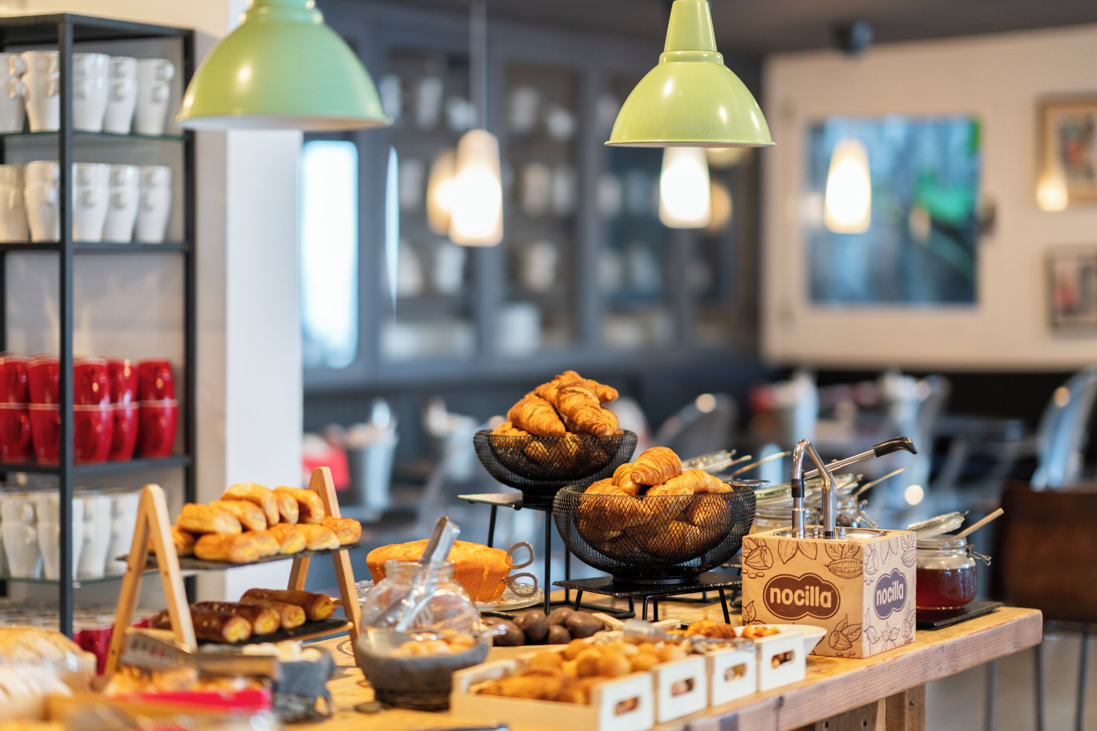 A bakery display with various baked goods and a 'nocilla' jar.