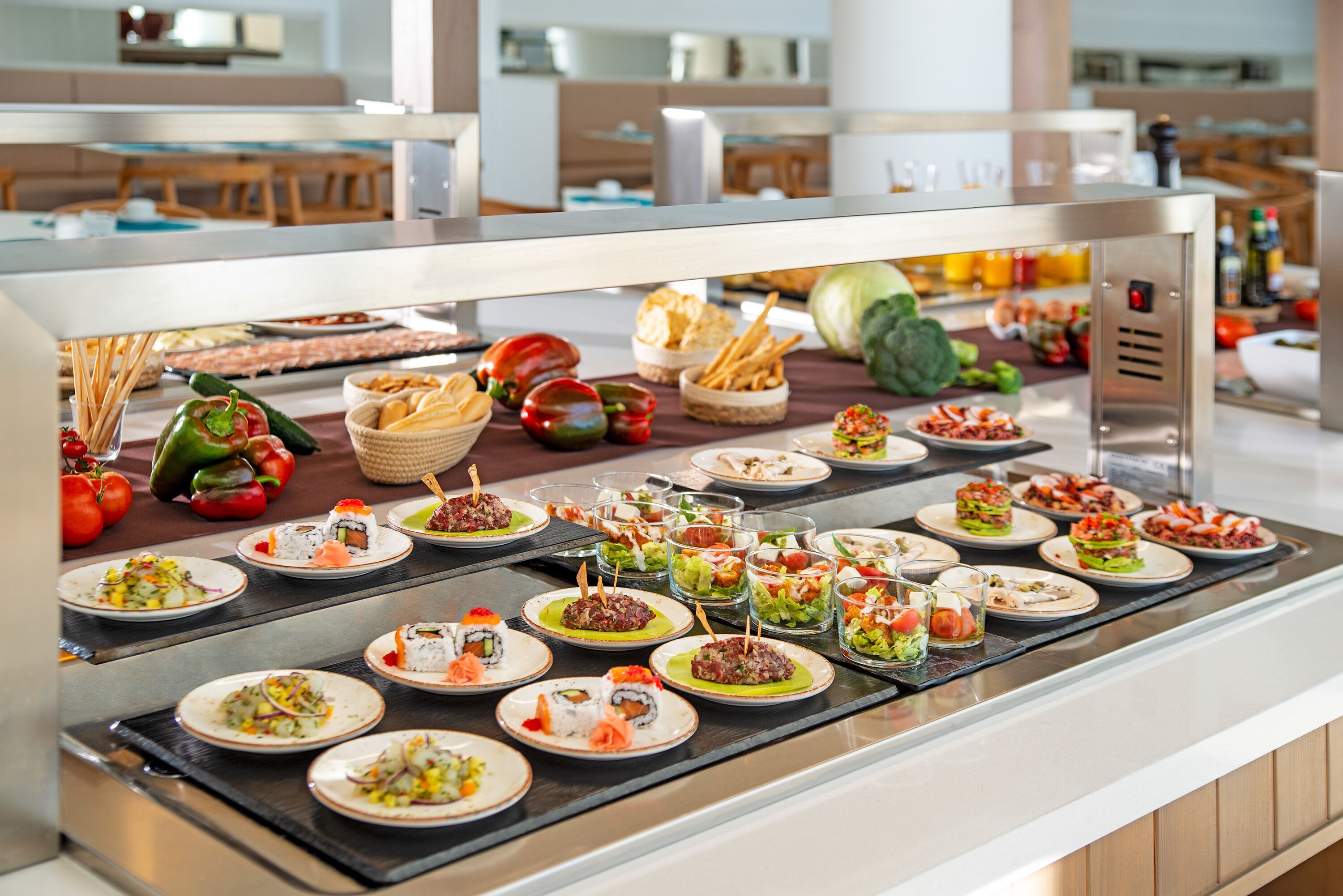 A buffet with various dishes, including sushi, salads, and bread.