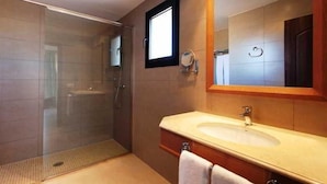 A modern bathroom with a glass-enclosed shower, a large mirror, and a vanity with a sink. - Sa Bassa Plana (Llucmajor)
