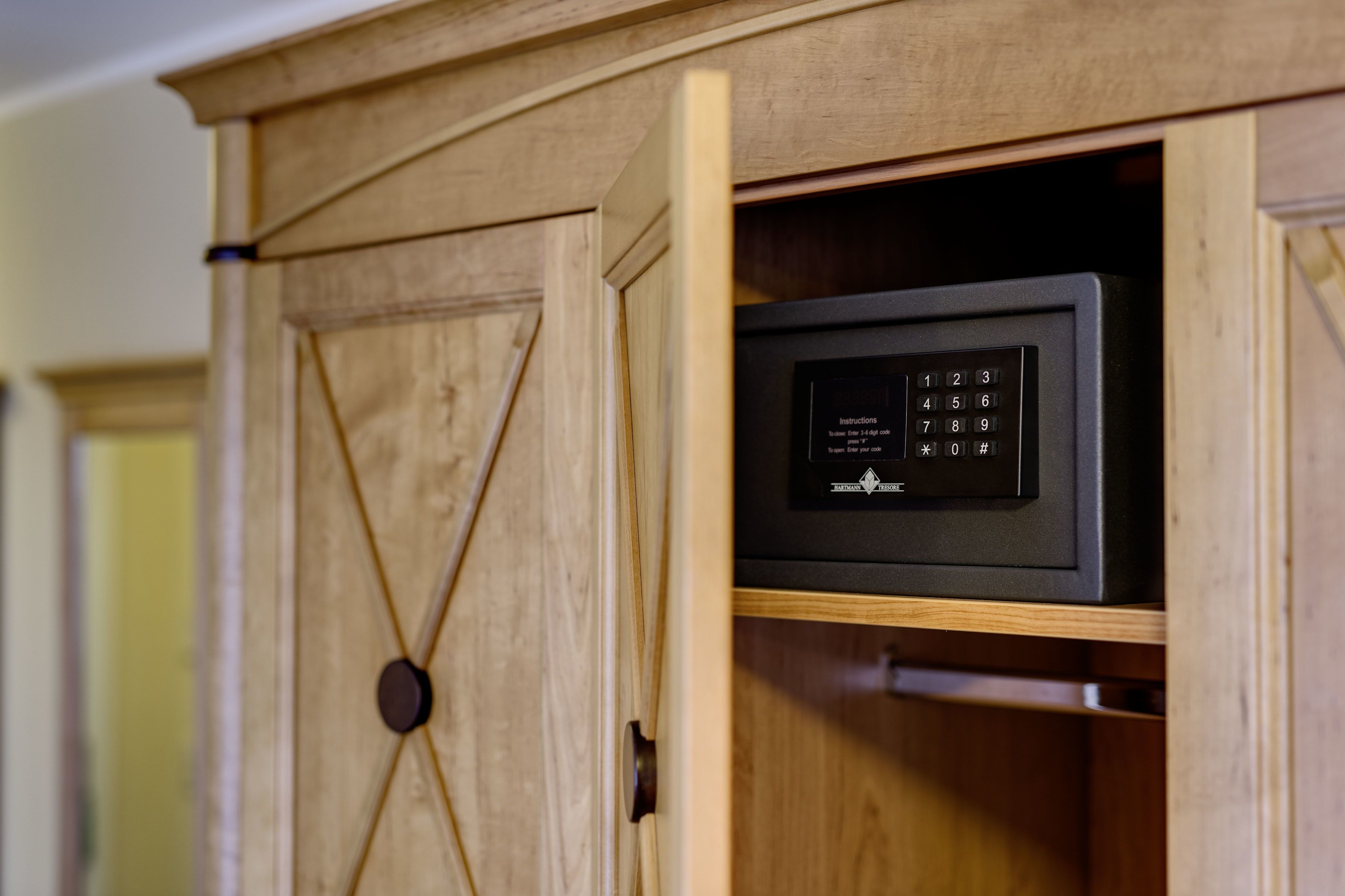 A wooden cabinet with a built-in microwave.
