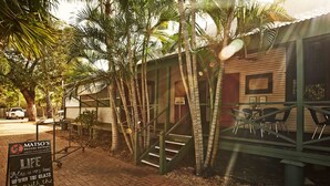 A brick pathway leading to a building with a signboard for Matso's Broome Brewery. - Bayside Holiday Apartments (Broome)