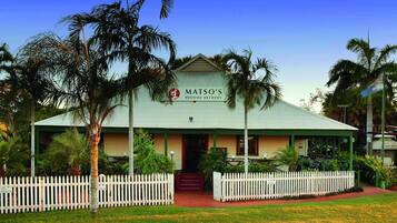 A building with a sign reading "MATSO'S BROOME BREWERY" and a white picket fence in front.