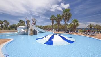 Relax by the pool surrounded by palm trees and lounge chairs, where kids can enjoy a fun water slide.
