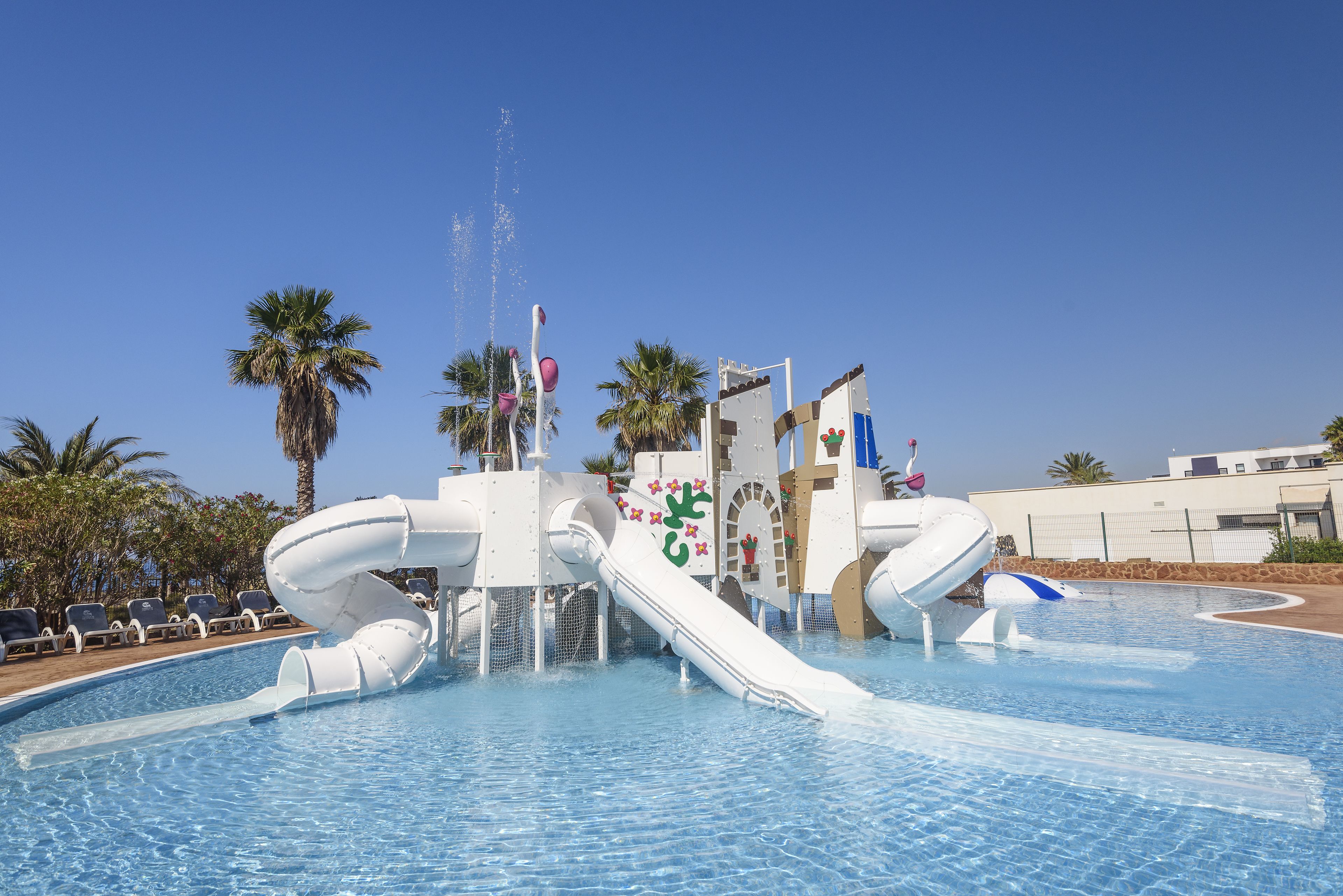 A water park with a large slide and water jets.