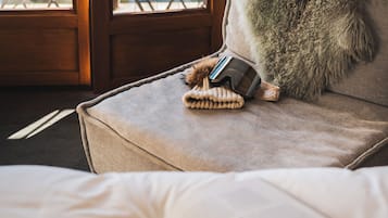 Une chambre à coucher avec un lit, un oreiller, un livre et une paire de lunettes de soleil posées sur le lit.