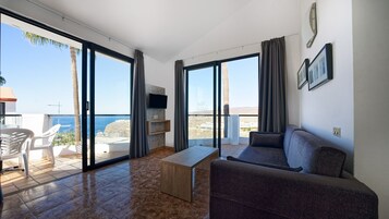 Apartment, 1 Bedroom | Living room | Flat-screen TV