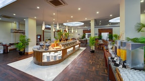 A spacious hotel lobby with a central buffet area, multiple seating arrangements, and a modern design. - Sokha Beach Resort (Sihanoukville)