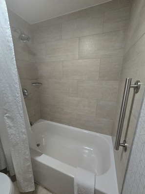 A bathroom with a bathtub, a shower, and a toilet.