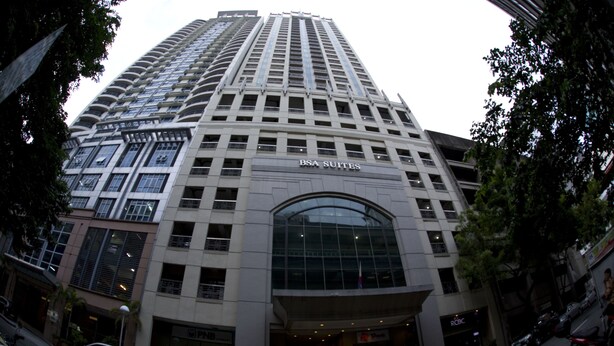 A high-rise building with the sign "BSA SUITES" indicating it is a hotel. - BSA Suites Makati (Makati)