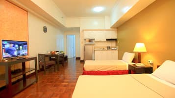 Premier Triple Room, 1 Bedroom | Living area | Flat-screen TV