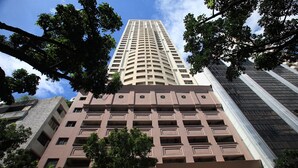 A high-rise building with a modern architectural design, featuring multiple balconies and a central core. - BSA Tower Serviced Residences (Makati)
