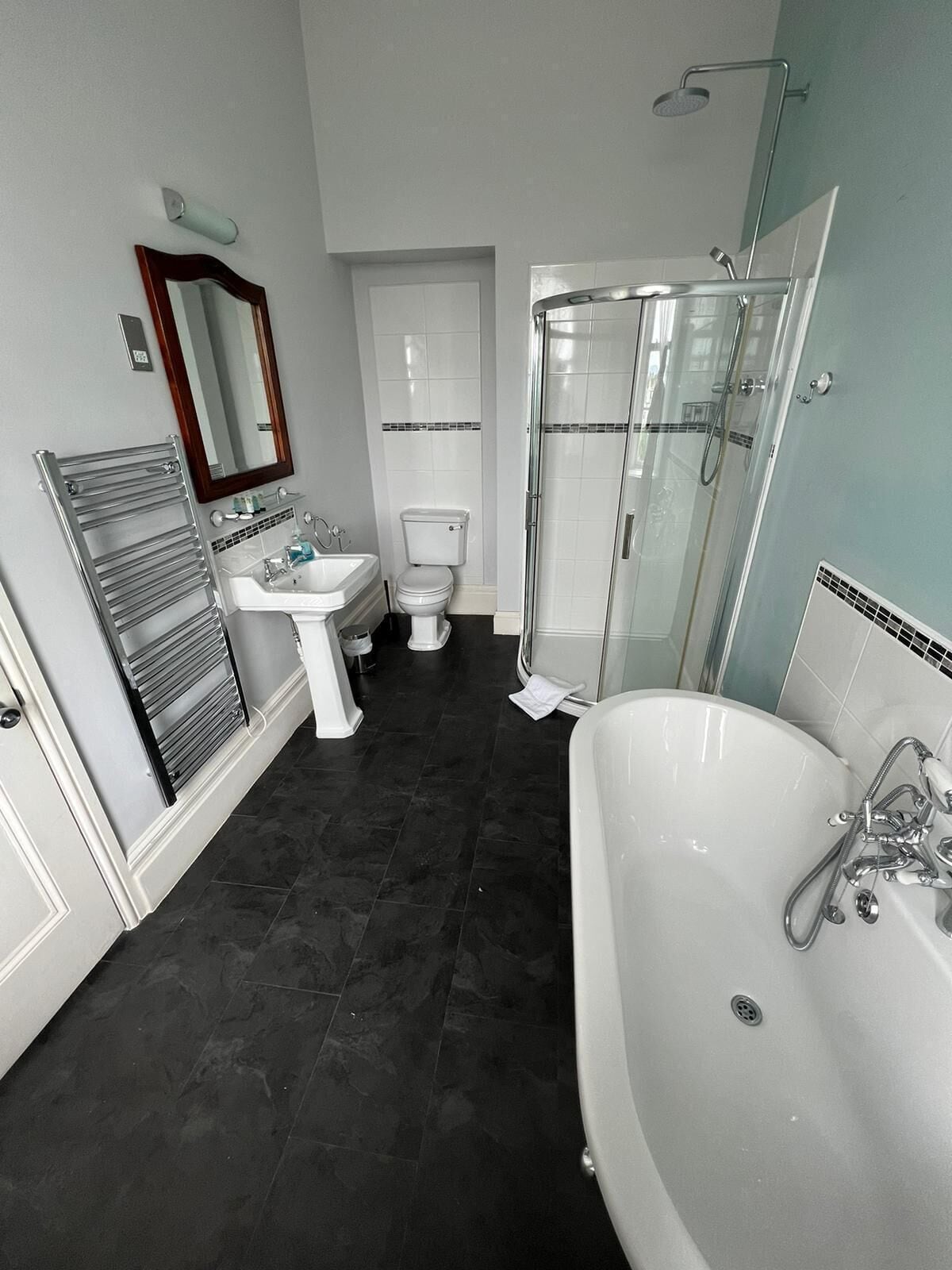 A modern bathroom with a bathtub, a glass shower enclosure, a sink, and a toilet.