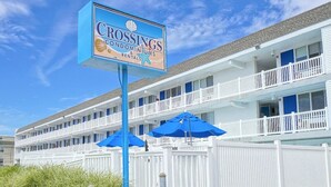 A beachfront motel with a sign for Crossings Condominiums & Rentals. - The Crossings (Ocean City)