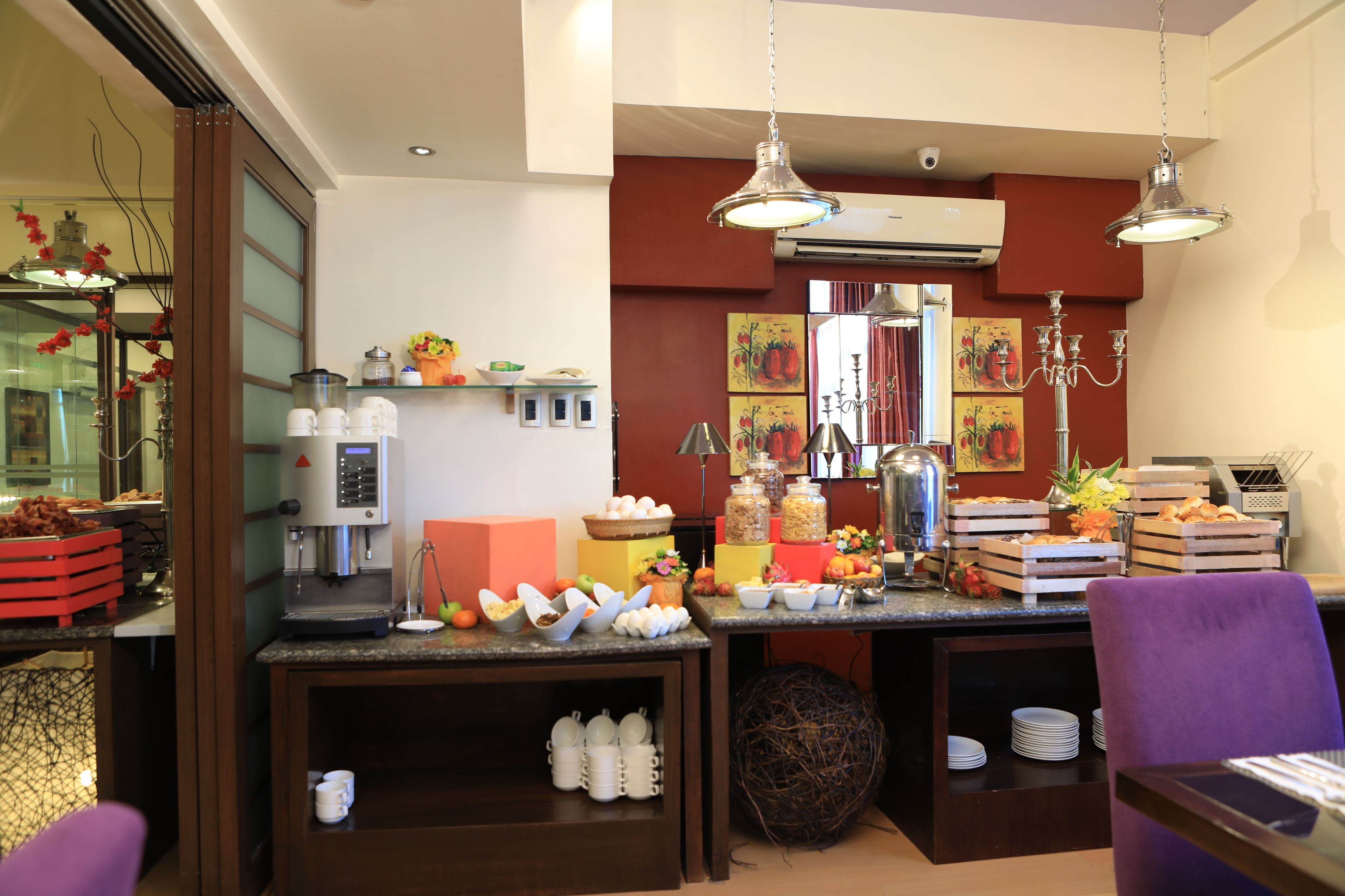 A breakfast bar with various food items and a coffee machine.