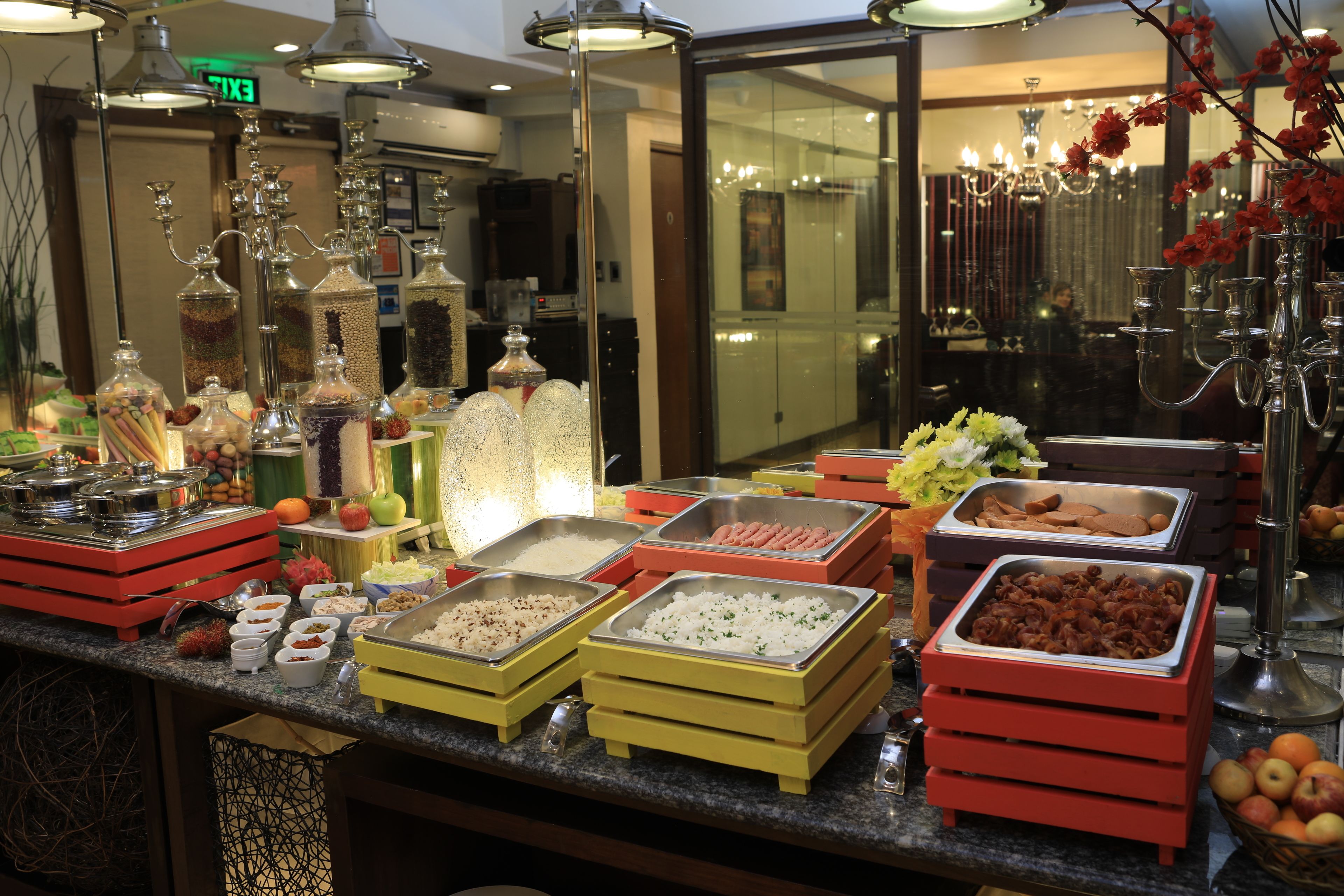 A buffet setup with various food items and decorative elements.