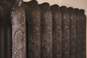 A close-up of ornate, dark-colored furniture with intricate carvings. - Locanda de' Ciompi (Florence)